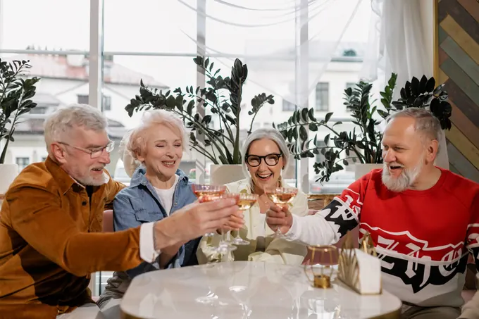 Four friends toasting over lunch
